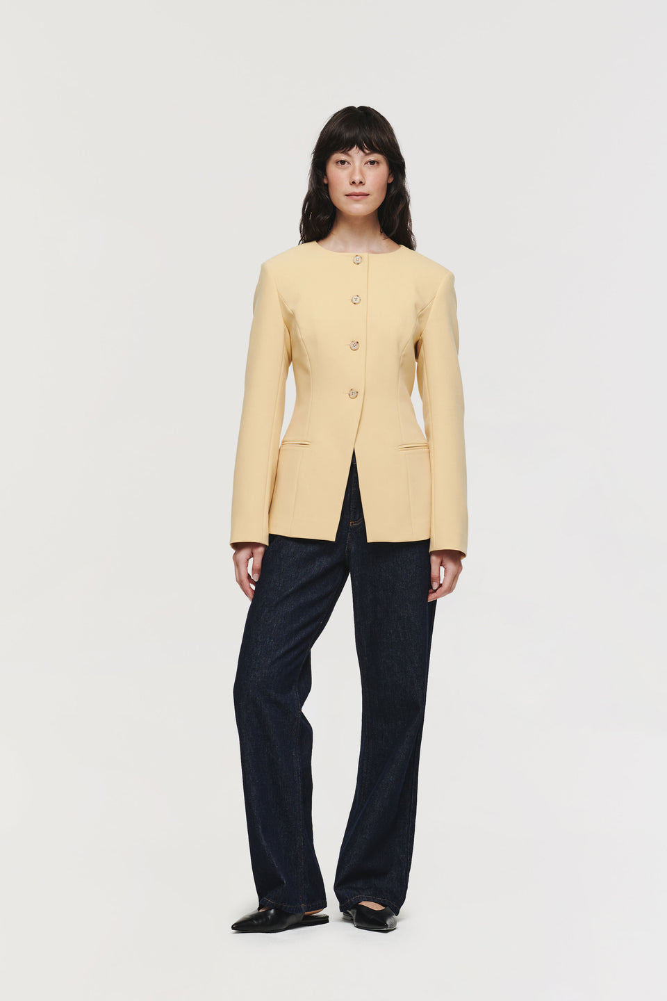 Daphne is the long sleeve version of our popular Leo waistcoat. Finished with a curved neckline, contrast buttons and in a striking soft yellow hue that works well as an eye-catching statement. Pair with the matching KIMMI trousers for a co-ordinated outfit or a wear with straight leg jeans for a look that feels more casual.